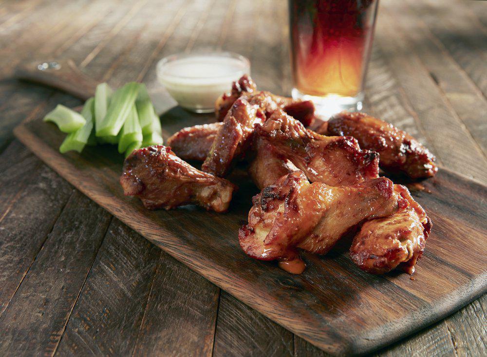 Oven Roasted Wings · Crisp double-baked wings. Choose from hot, mild, BBQ, jerk, sweet Thai chili or naked. Served with celery, carrots and your choice of ranch or bleu cheese dressing.