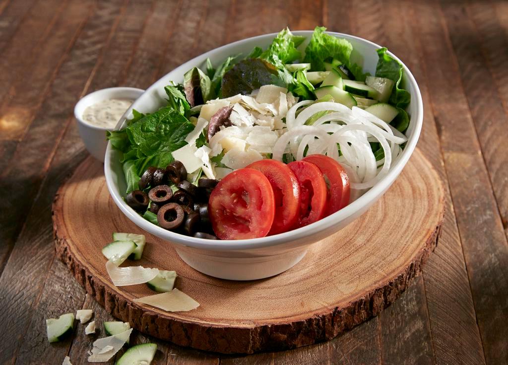 House Salad · Spring mix and romaine with Roma tomatoes, cucumbers, black olives and onions topped with shaved Parmesan. We suggest balsamic vinaigrette with this salad. Lacto-ovo vegetarian.