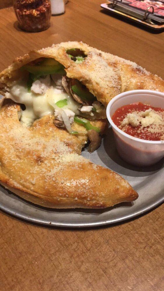 Chicken and Cheese Calzone · Grilled all-natural chicken with mushrooms, onions, green peppers, seasoned ricotta, mozzarella and provolone.