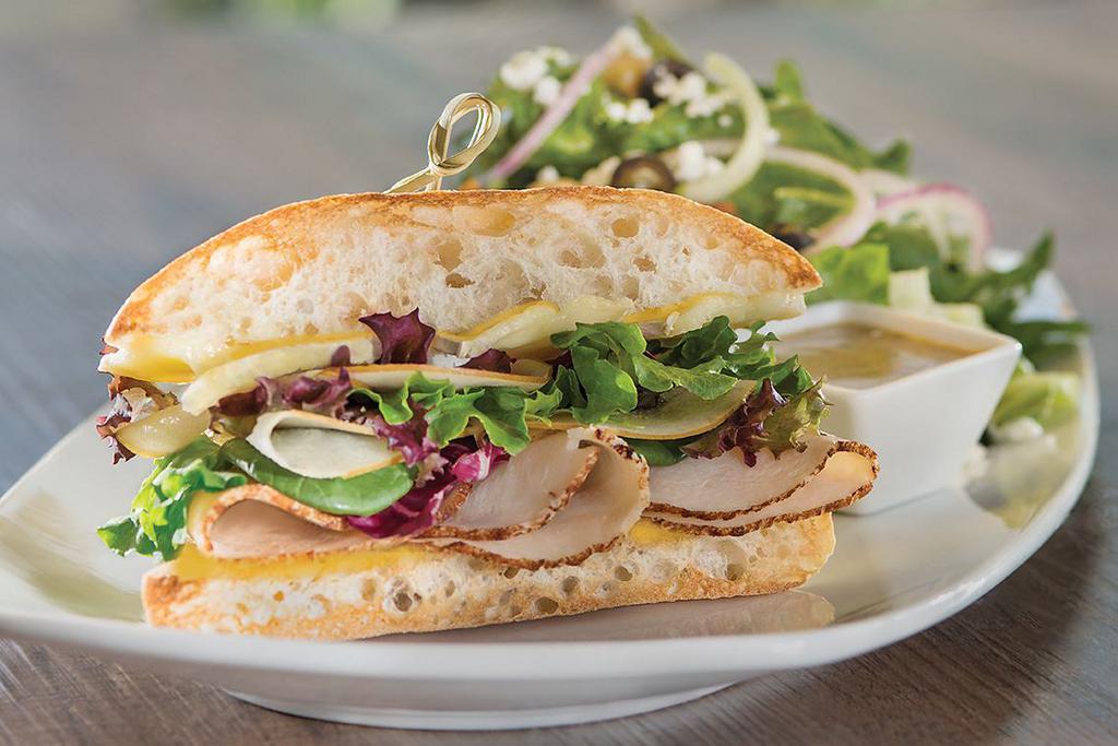 Oven-Roasted Turkey and Brie Half Sandwich Lunch Duo · With shaved Granny Smith apple, baby greens and housemade honey-mustard. Served with choice of salad or cup of soup.