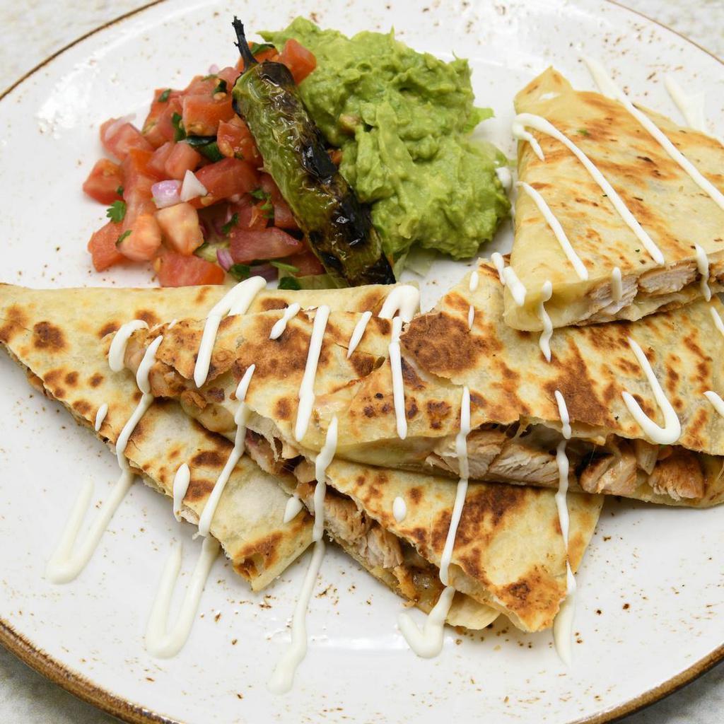 Quesadilla De Pollo · Free range chicken breast, chipotle BBQ sauce, Mexican cheeses. Served with pico de gallo and guacamole.