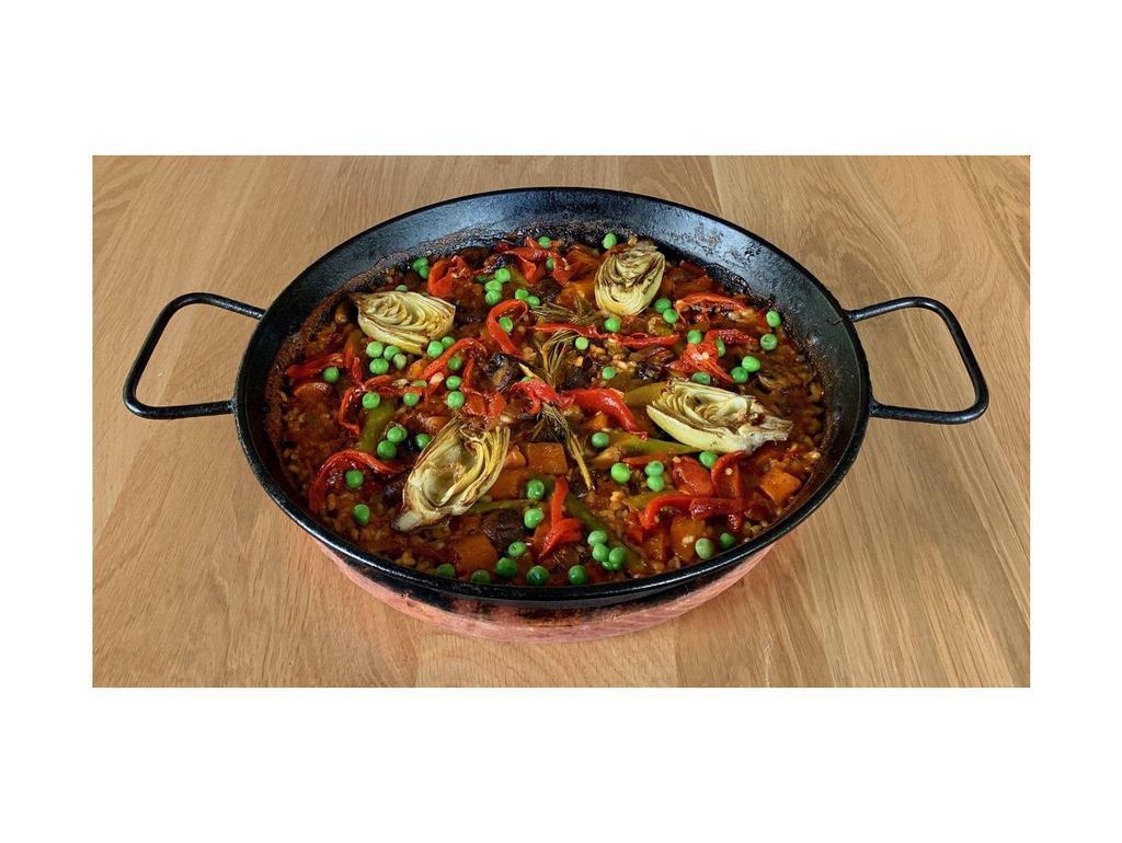 Paella Vegetales · Valencia style rice, Portobello mushrooms, asparagus, carrots, artichoke confit, green peas, kale, red sofrito, saffron.