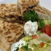 Quesadilla Con Carne · Cheesy and delicious quesadilla with your choice of meat.