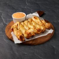 Garlic Parmesan Twists · Freshly rolled dough seasoned with fresh garlic, our 3 cheese blend, Parmesan cheese and bak...
