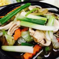Udon Veggies · Udon noodles with mixed veggies in simmering broth.