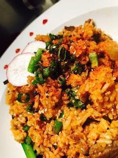 Kimchi Fried Rice · Stir fried rice with kimchi, gachujang hot pepper paste, eggs, tofu, sesame seeds and scallion.