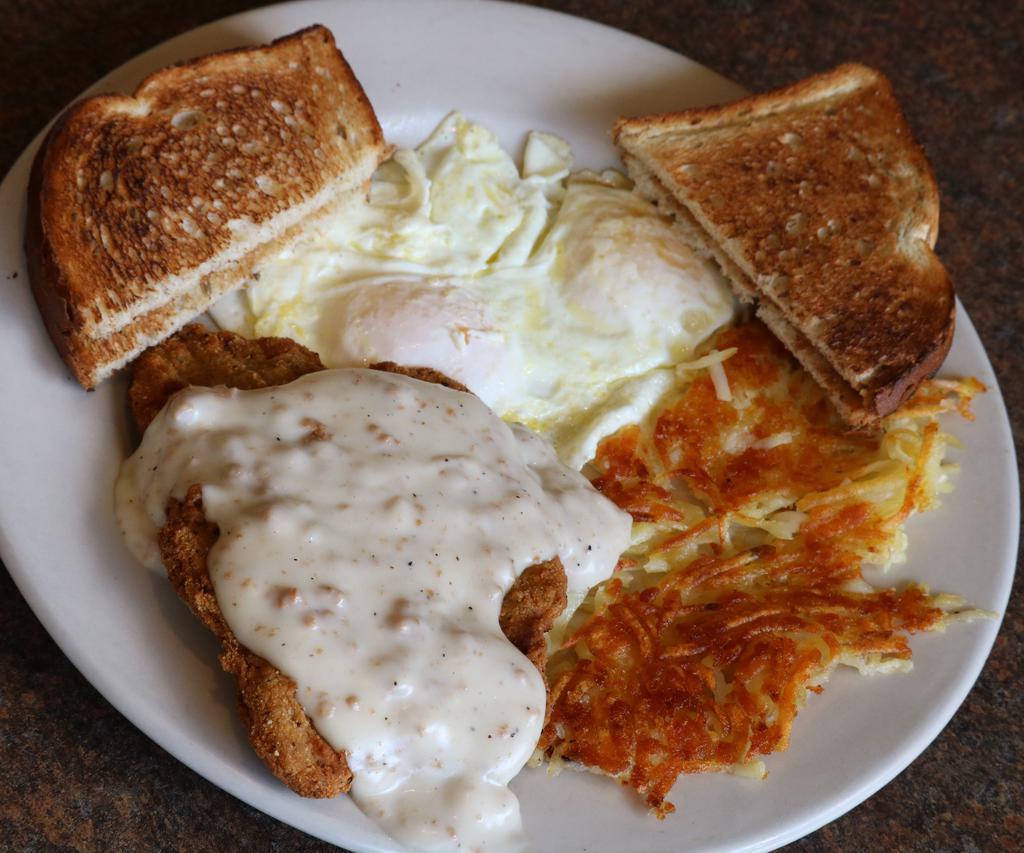 Country Fried Steak and Eggs · Country fried steak in sausage gravy and 2 eggs any style. Served with hash browns and choice of whole wheat, white, or rye bread. Add-ons for an additional charge.