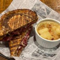 Reuben Panini · Thinly sliced corned beef, swiss cheese, saur kraut, 1000 island dressing, Served on marble ...