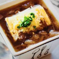 Paris French Onion Soup · Caramelized onions and red wine with a slice of bread and melted grated cheese.