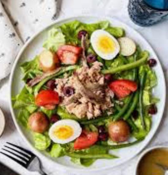 Salade Nicoise · Mixed greens, tuna, tomatoes, green beans, hard-boiled egg, red pepper, celery and red onions.