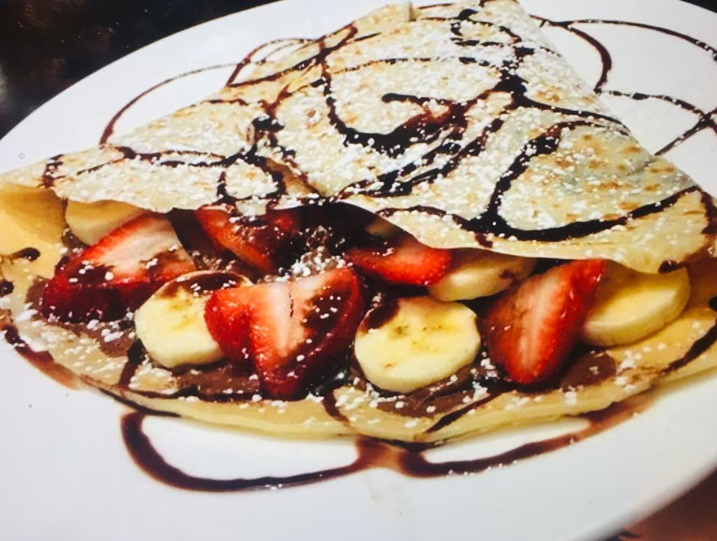 Crepe Royale · Fresh bananas and strawberries, Nutella and chocolate sauce. Served with whipped cream and powdered sugar.