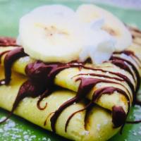 Crepe a la Banane · Fresh bananas, Nutella and chocolate sauce. Served with whipped cream and powdered sugar.