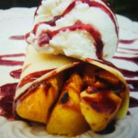 Crepe Melba · Fresh peaches and strawberries, homemade berry sauce and vanilla ice cream. Served with whip...