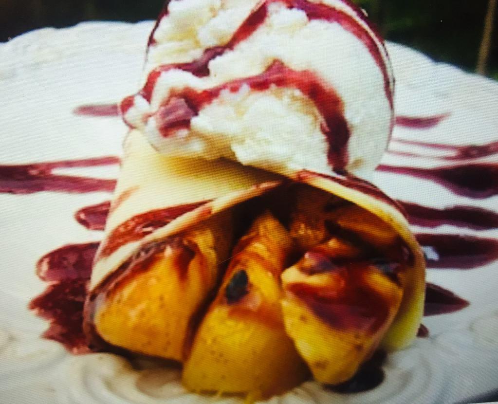 Crepe Melba · Fresh peaches and strawberries, homemade berry sauce and vanilla ice cream. Served with whipped cream and powdered sugar.