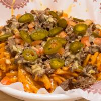 Famous Philly Cheese Fries · Our waffle fries topped with choice of beef or chicken and homemade queso and jalapenos.