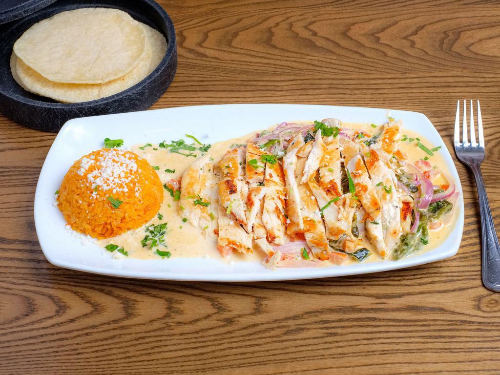Chicken Anaheim · Grilled chicken roasted with Anaheim Chile, onion, cilantro and tomato in cream sauce served with rice and homemade corn tortillas.