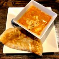 Roti Canai · Flaky pan seared flatbread served with chicken and chestnut massaman curry sauce.