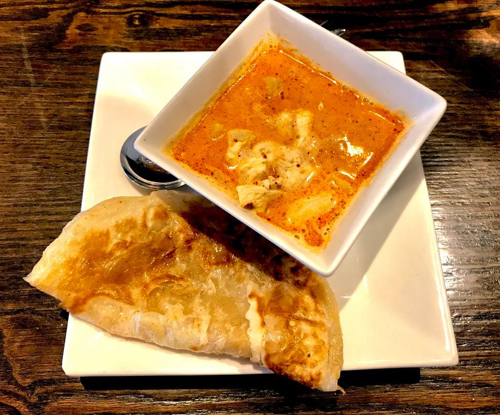 Roti Canai · Flaky pan seared flatbread served with chicken and chestnut massaman curry sauce.