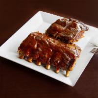 Baby Back BBQ Pork Ribs · Baby back ribs smothered in our House BBQ sauce. Served with potato salad or Coleslaw.  Choo...