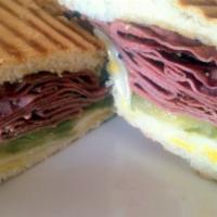 Pastrami Panini · Grilled extra lean pastrami, mustard, pickles and topped with Swiss cheese. Served on butter...