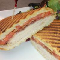Turkey and Applewood Bacon Panini · Smoked turkey, applewood smoked bacon, tomato, Swiss and mayo. Served on buttered and presse...
