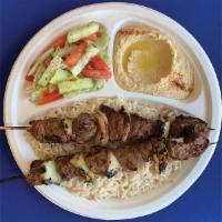 #1. Beef Kebab Plate · Grilled marinated beef cubes served over rice, with hummus and garden salad.