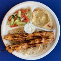 #3. Chicken Kabab Plate · Tawouk. Grilled marinated chicken breast served over rice, with hummus, garden salad and gar...