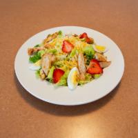 Ely's Chicken Salad · Grilled chicken breast, fresh strawberries, hard boiled eggs, diced tomatoes, mixed cheese a...