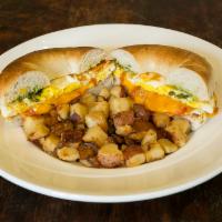 Cheesy Egg Sandwich · 2 fried eggs, bacon, tomato, cheddar, pesto sauce and a toasted bagel. Served with diced red...