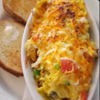 Veggie Casserole · Scrambled eggs, green peppers, onions, mushrooms & tomatoes on a bed of home fries topped wi...