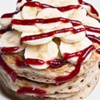 PB&J Pancakes · Non-GMO whole grain whey protein pancakes topped with peanut butter, banana, and sugar-free ...