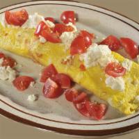 Grecian Omelet · Feta cheese and topped with diced tomatoes. Gluten free. Vegetarian.