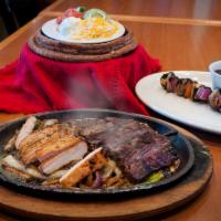 Combination Fajitas · Both chicken and steak fajitas served with on a sizzling hot platter. 