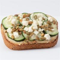 Wholesome Hummus Toast · Whole Grain Bread, Hummus, Cucumber, Lemon Tahini Vinaigrette, Feta Cheese, Pepitas