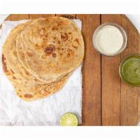 Paratha · 1 piece of layered and lightly fried paratha on a cast iron griddle.