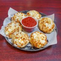Garlic Knockers · Our house-made dough stuffed with fresh garlic and mozzarella, tied in a knot. Served with 4...