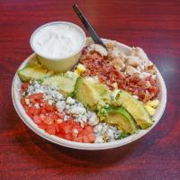 Cobb Salad · Chopped romaine lettuce, tomato, avocado, bacon, hard-boiled egg, blue cheese crumbles and g...