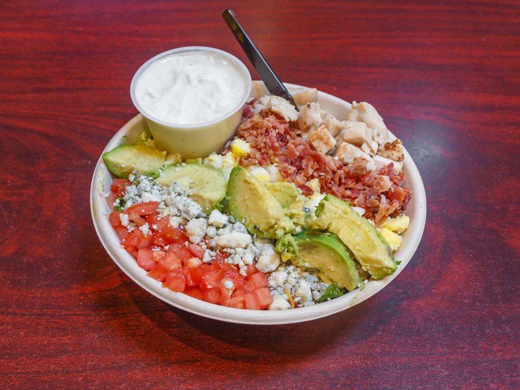 Cobb Salad · Chopped romaine lettuce, tomato, avocado, bacon, hard-boiled egg, blue cheese crumbles and grilled chicken.