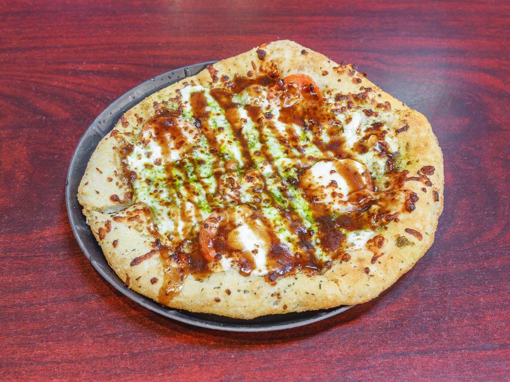 Caprese Pizza · Pesto base, fresh mozzarella, feta cheese, tomato slices, and balsamic drizzle. Add Beyond Meat for an additional charge. 