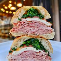 #7. Off the Bone Sandwich · Fresh ham, fresh mozzarella, tomato, broccoli rabe on ciabatta.