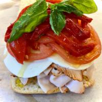 #22. Bambino Sandwich · Cracked pepper turkey, fresh mozzarella, tomato, basil, roasted peppers, & olive oil on foca...