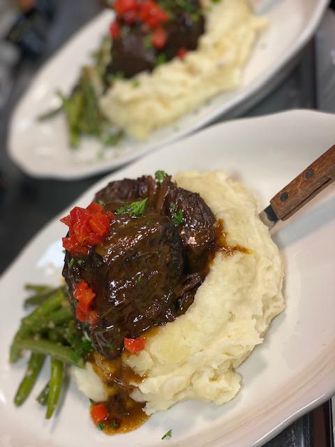 Costilla de Res Plate · Roja braised short ribs, creamy yuca mashed and charred green beans.