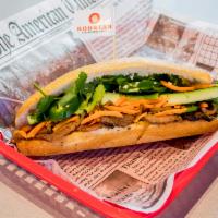 Sous Vide Pork Belly Banh Mi · Pork Belly off the bone texture served warm. Served with garlic aioli, pickled carrots, cucu...