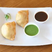 Samosa · 2 savory dough pastries stuffed with potatoes, peas and spices.