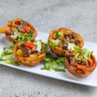 Tostones Rellenos · Stuffed green plantain cup of beef or shrimp.