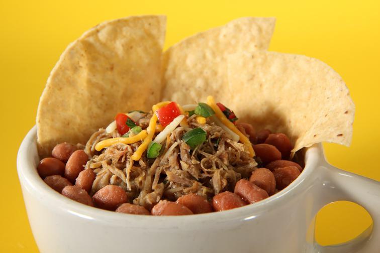 Drunken Pig · Borracho beans with spicy pork, pico de gallo, chips and shredded cheese.