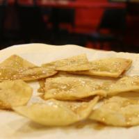 Sopapilla Chips · Flour tortilla chips lightly fried and topped with cinnamon-sugar and honey.