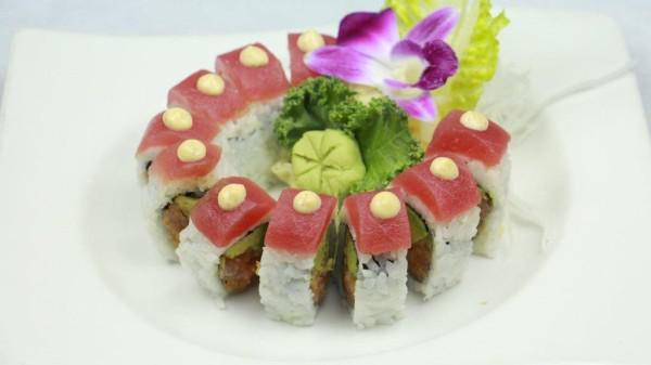Crunchy Spicy Tuna Roll · Spicy tuna, tempura flake, avocado and sesame seeds with tuna on top. Spicy.