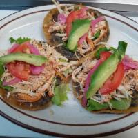 Chicken Panucho · Fried handmade corn tortilla, stuffed with black beans, topped with lettuce ,  tomatoes, avo...