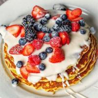 Signature Honeyberry Pancake · Berry mascarpone filling, freshberries, venilla cream anglaise & blackberry coulis, lime zest.